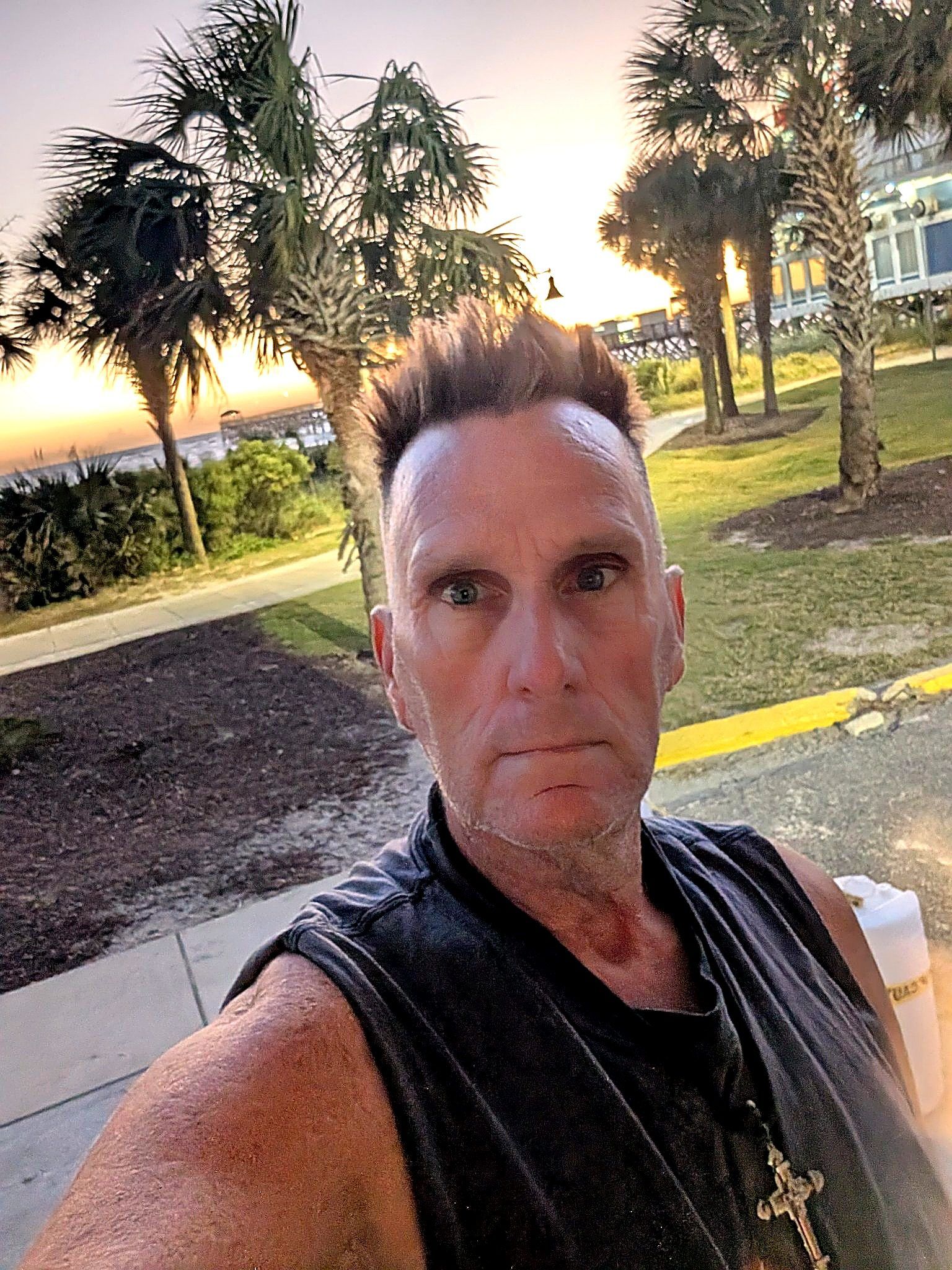 Real photo — enhanced: Coach RODA selfie at sunset, palms and the pier behind him — Myrtle Beach, SC, Oct 26, 2026