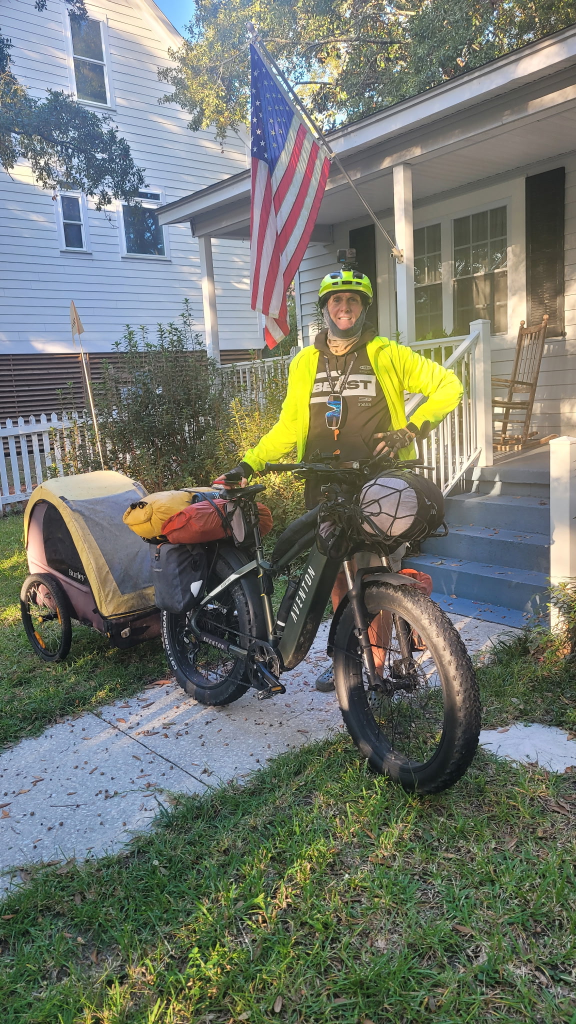 Real photo: Coach RODA with The Beast and The Sherpa under the flag on Mama D's porch, Georgetown, SC — Oct 28, 2026